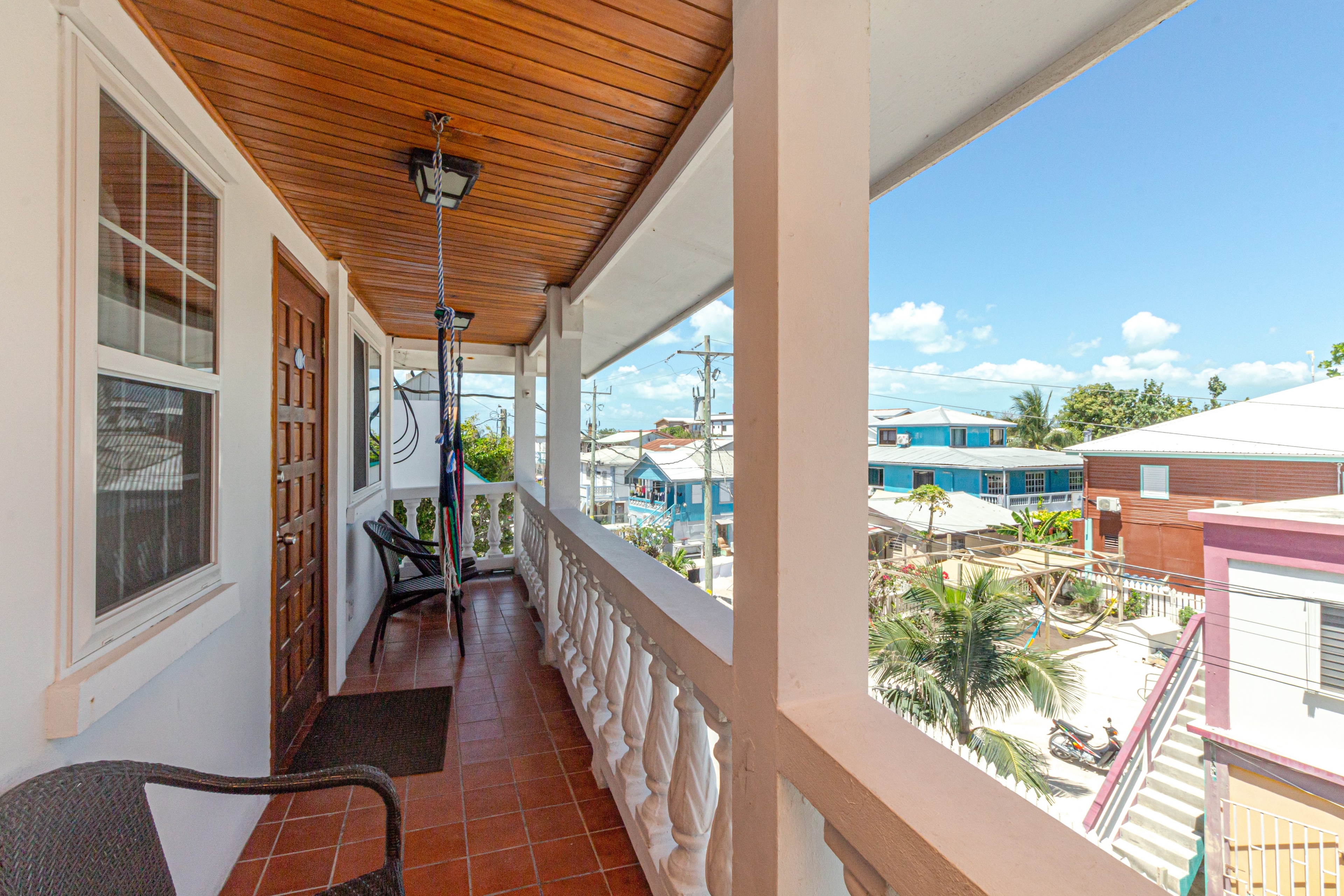 Balcony View with chairs, hammock, tile floor and wood ceiling