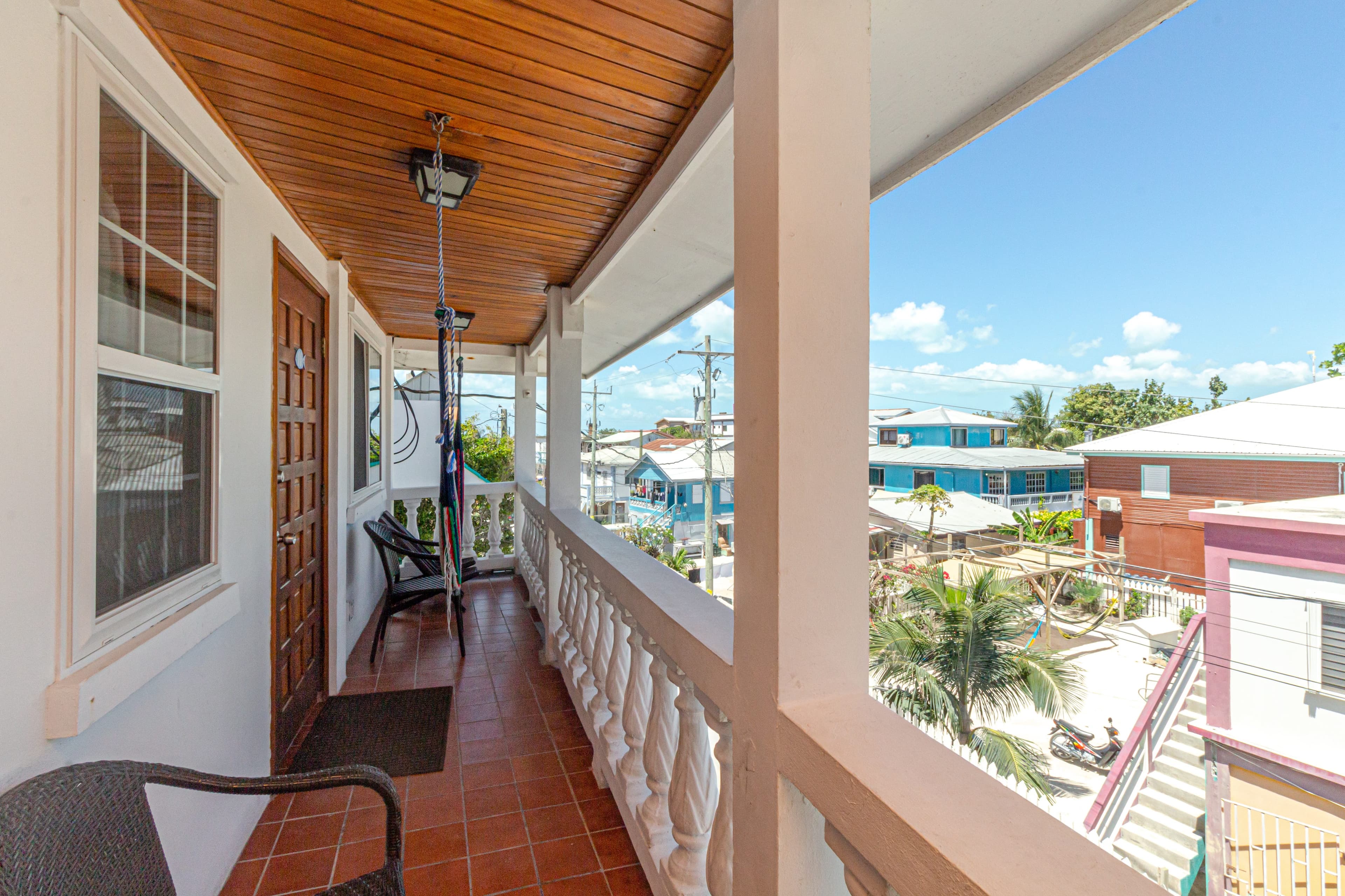 Balcony View with chairs, hammock, tile floor and wood ceiling