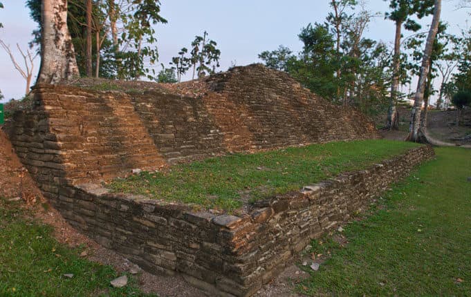 Ancient stone ruins surrounded by greenery.