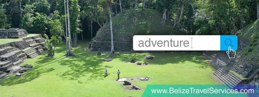 An aerial view of ancient ruins surrounded by lush greenery, with two individuals exploring the site.