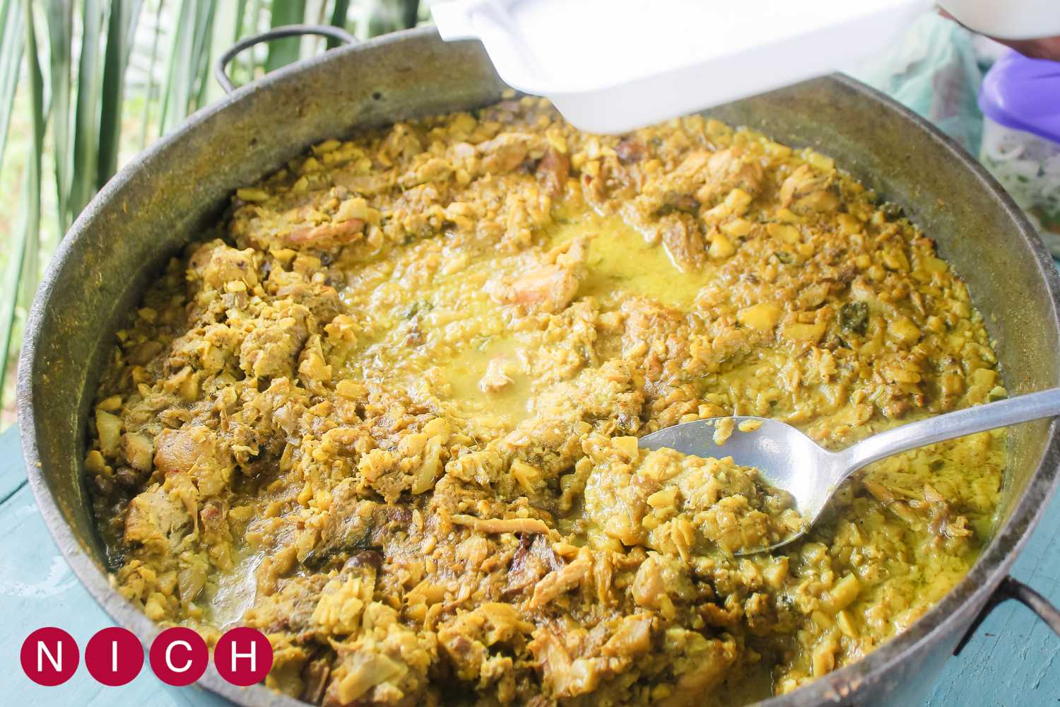 A large pot filled with seasoned rice and meat, ready to be served.