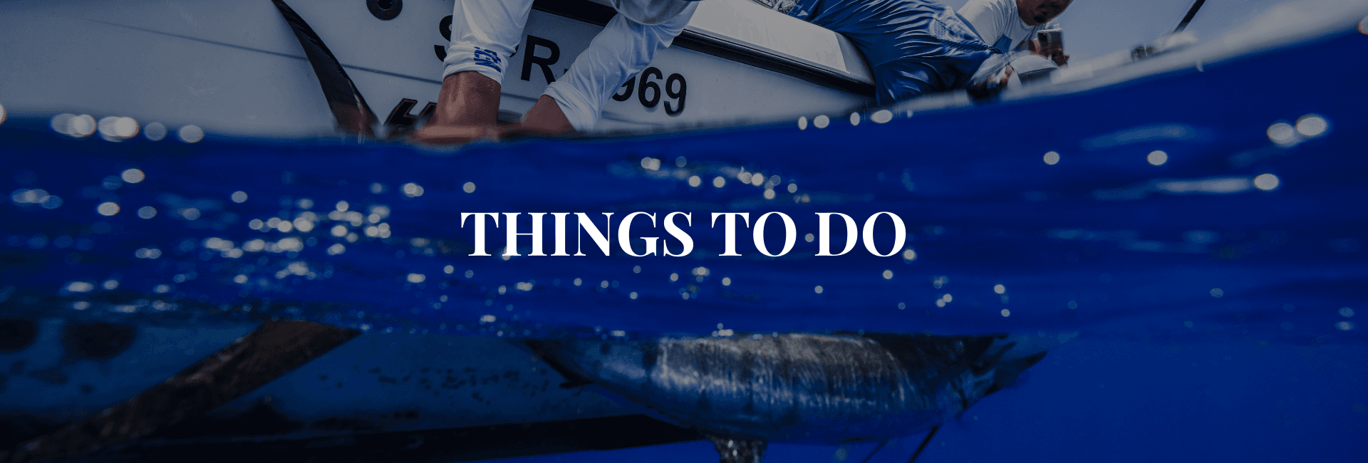 A person is seen reaching into the water from a boat, with the text "Things to Do" overlaid.
